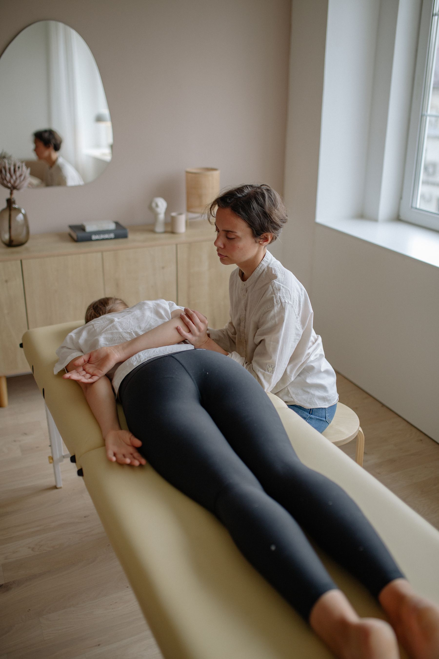 A massage practitioner applying a supervised hands-on technique